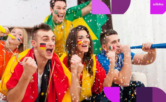 Colaboradores diversos com pinturas no rosto e bandeiras, celebrando com confetes e cornetas, ilustrando o engajamento de equipes durante a Copa do Mundo.