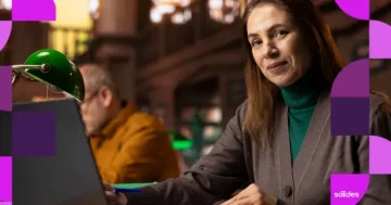 Mulher trabalhando no notebook em ambiente de escritório, representando o bem-estar profissional e a retenção de talentos.